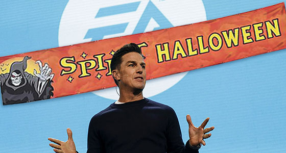 Andrew Wilson, Chairman & CEO of Electronic Arts standing in front of a Spirit Halloween banner partially blocking the EA logo.